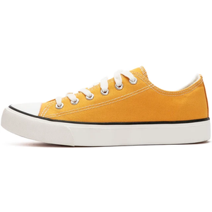 Yellow sneaker with white laces on a white background